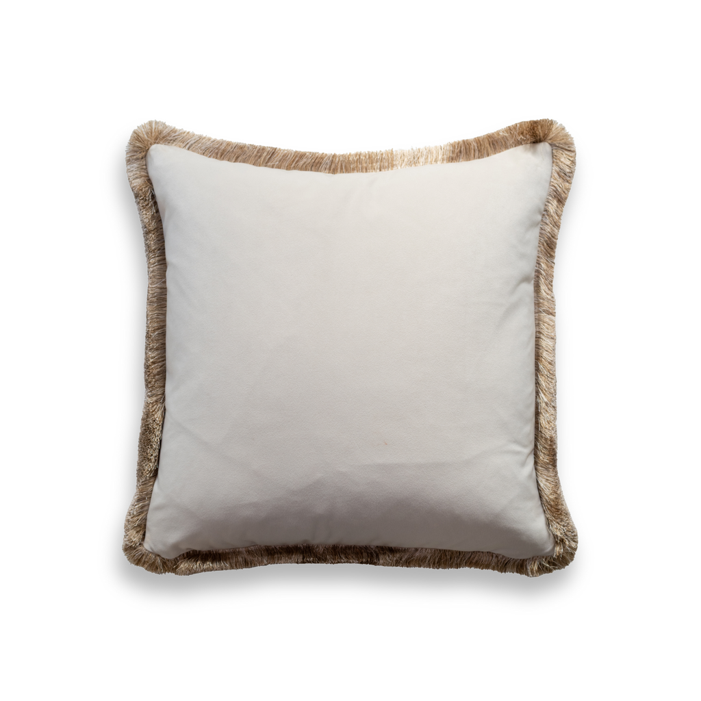 Product shot of the back of a decorative cushion which features a smooth white fabric with an elegant gold fringe around the edge of the cushion.